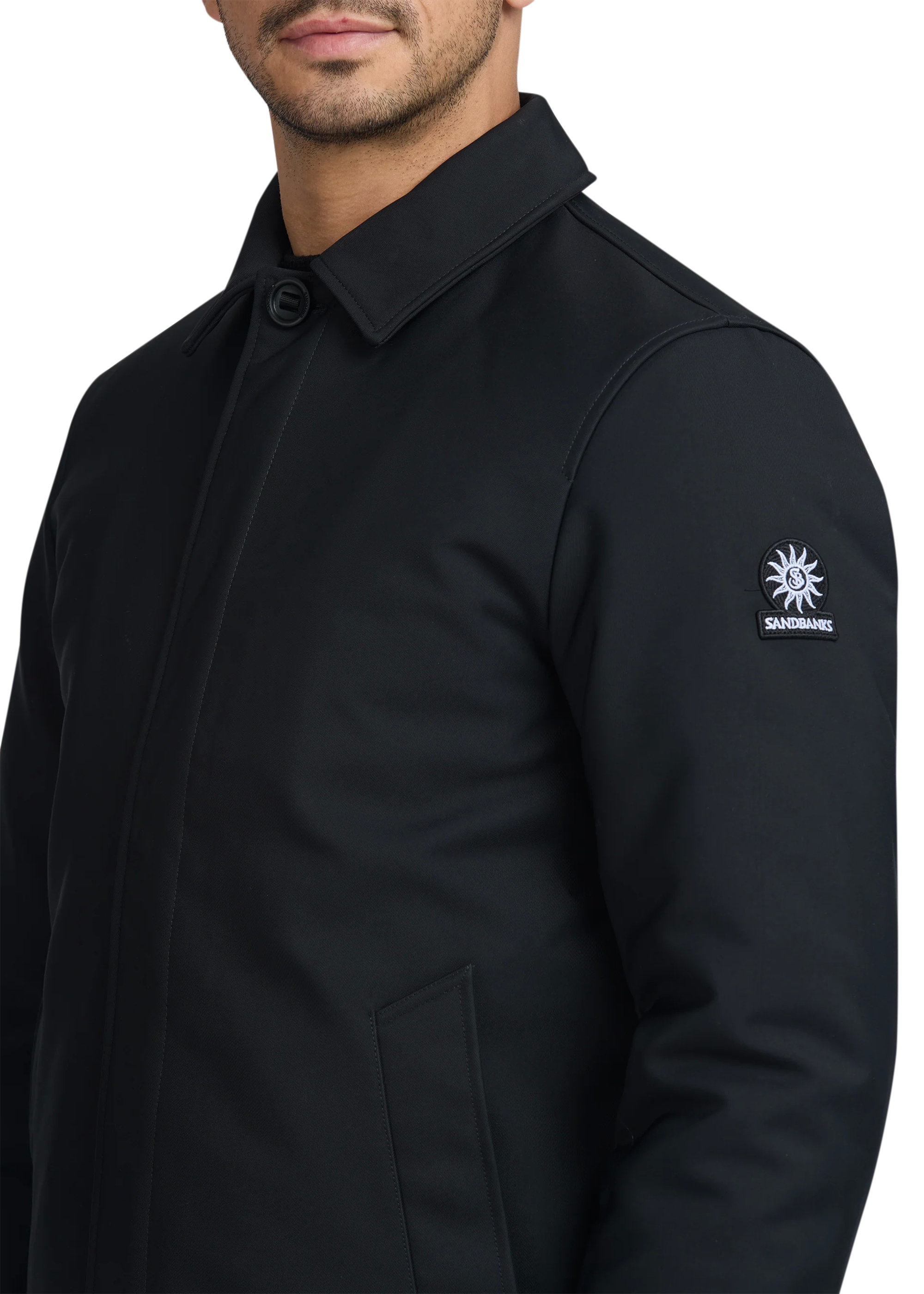 Black coat with a brand logo on the sleeve against a white background