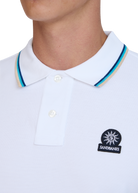 White polo shirt with sandbanks logo on the chest against a white background