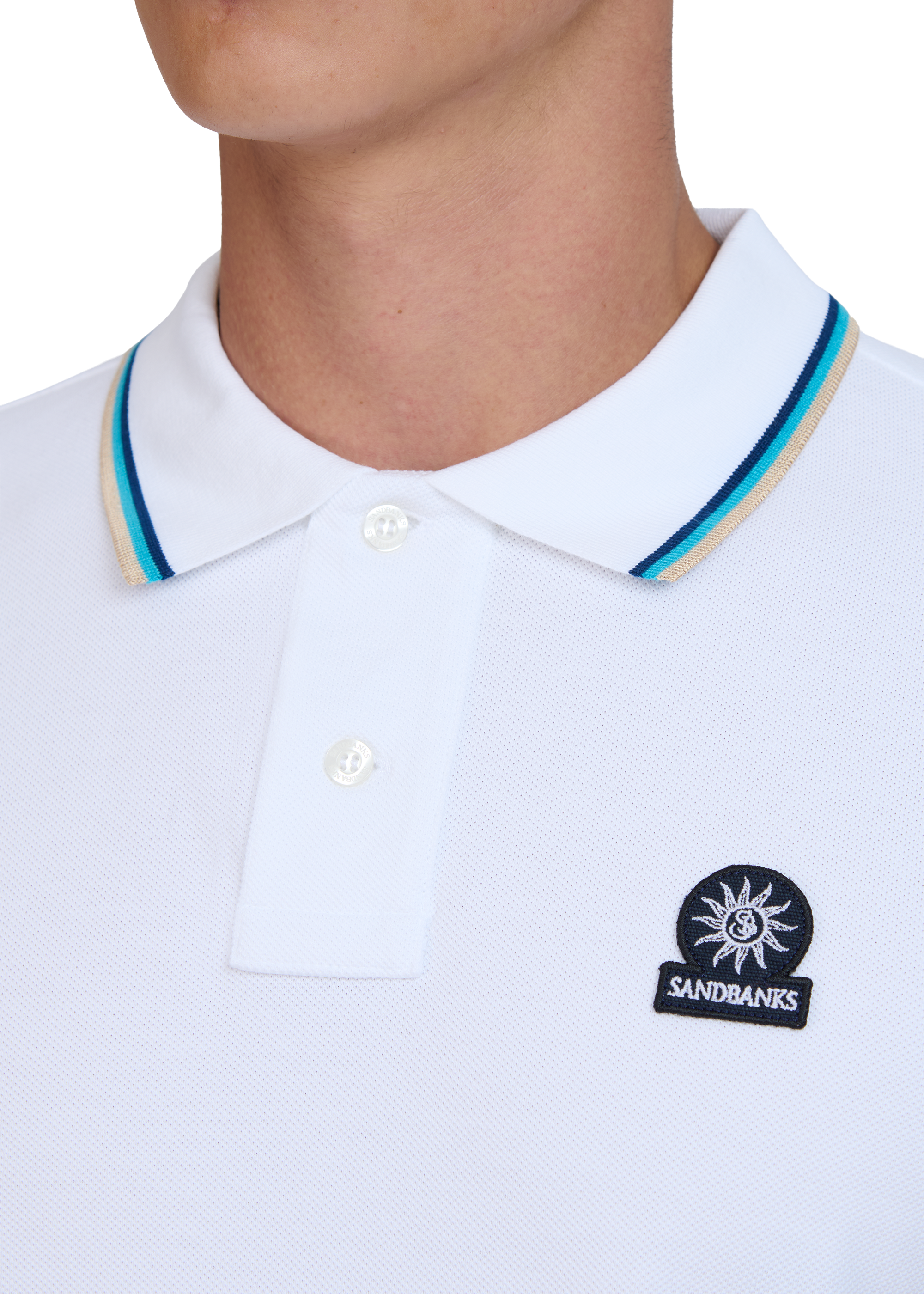 White polo shirt with sandbanks logo on the chest against a white background