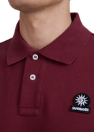 Model wearing Sandbanks Badge Logo Pique Polo Shirt - Port