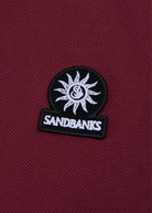 Model wearing Sandbanks Badge Logo Pique Polo Shirt - Port