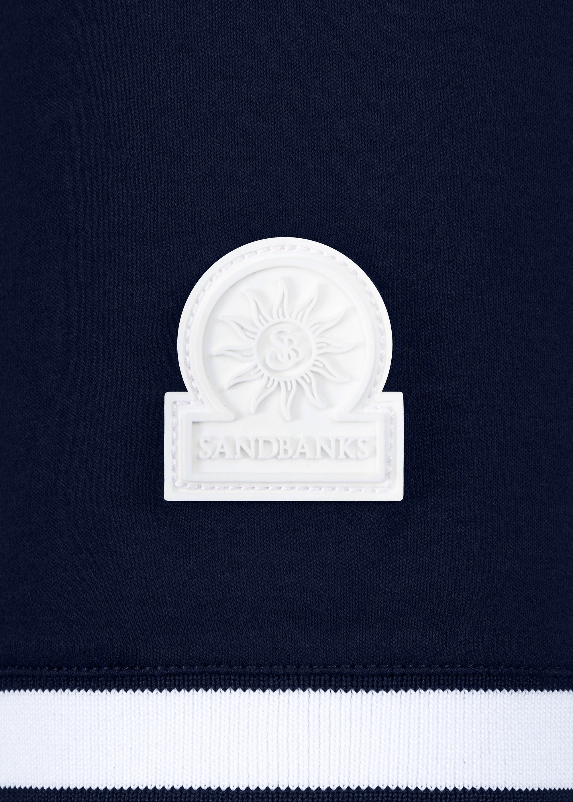White emblem with 'Sandbanks' text on a navy background