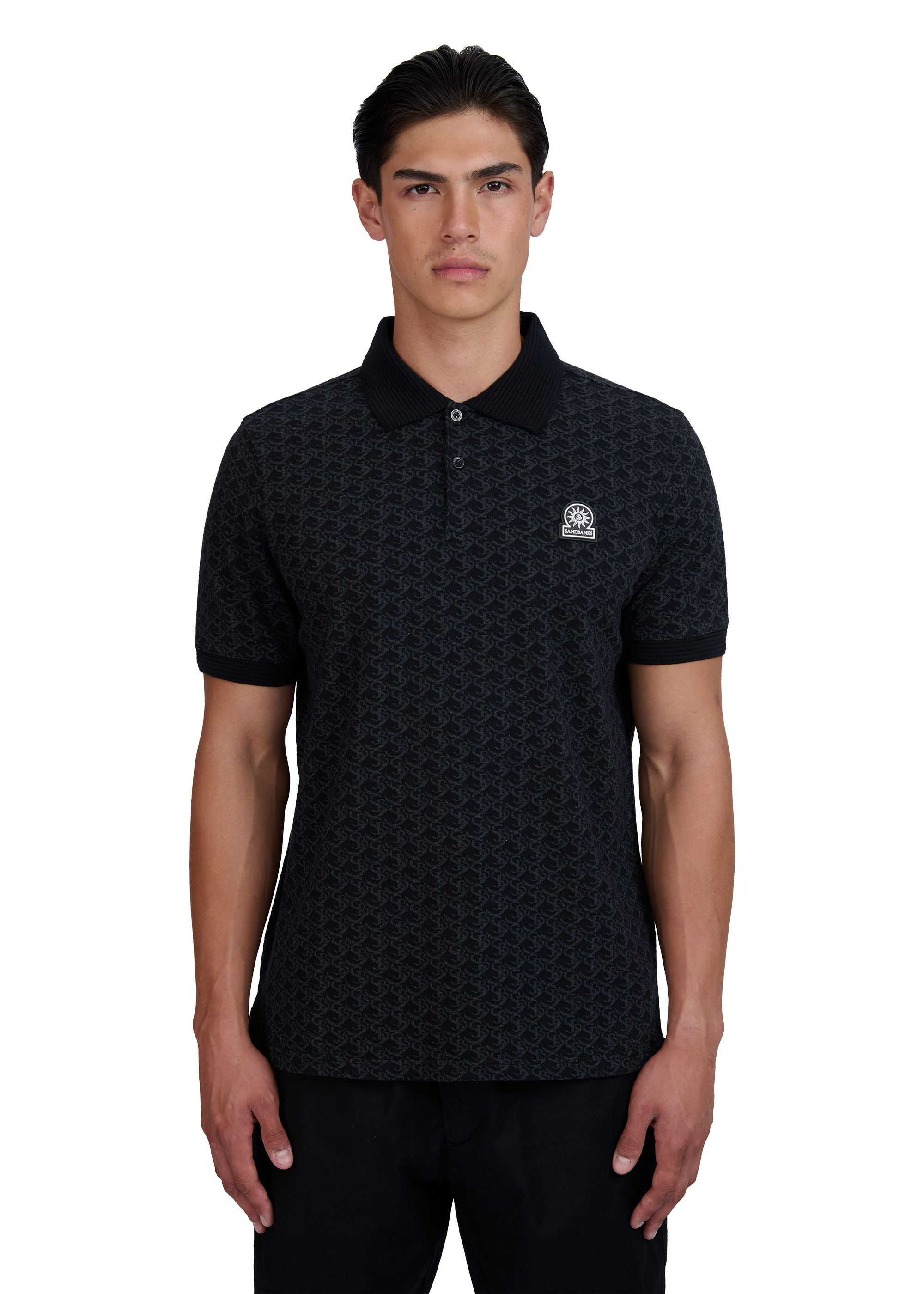 Model wearing a black patterned polo shirt with a logo on a white background