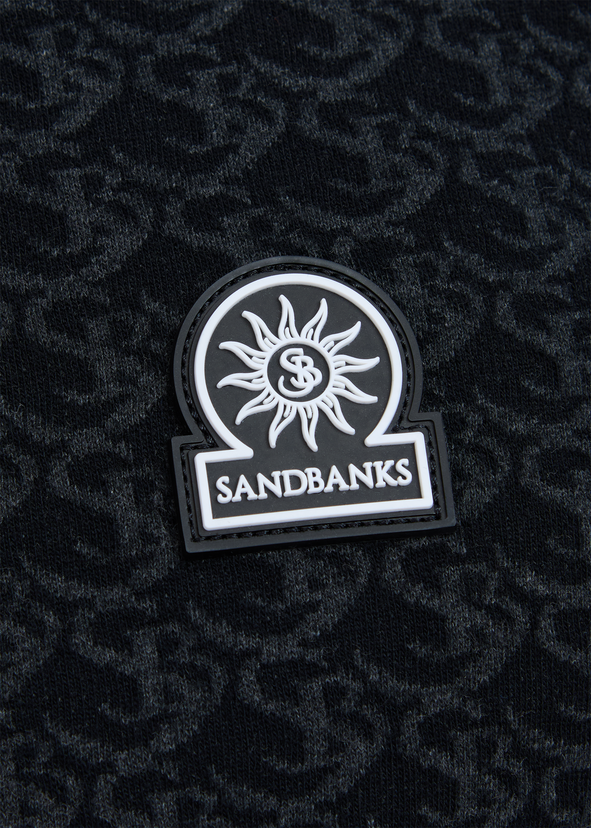Sandbanks logo patch on a textured black background