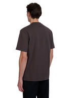 Model wearing a brown polo shirt on a white background