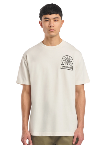 Model wearing a beige t-shirt with a logo on a white background