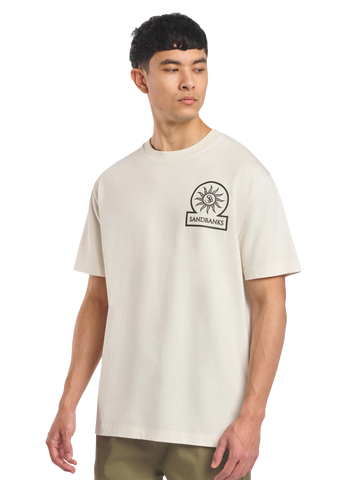 Model wearing a beige t-shirt with a logo on a white background