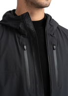 Close-up of a black jacket with a brand logo on a white background