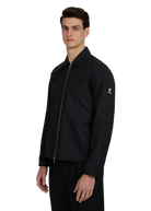 Man wearing a black jacket with a brand logo on a white background
