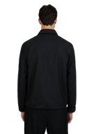Person wearing a black jacket on a white background