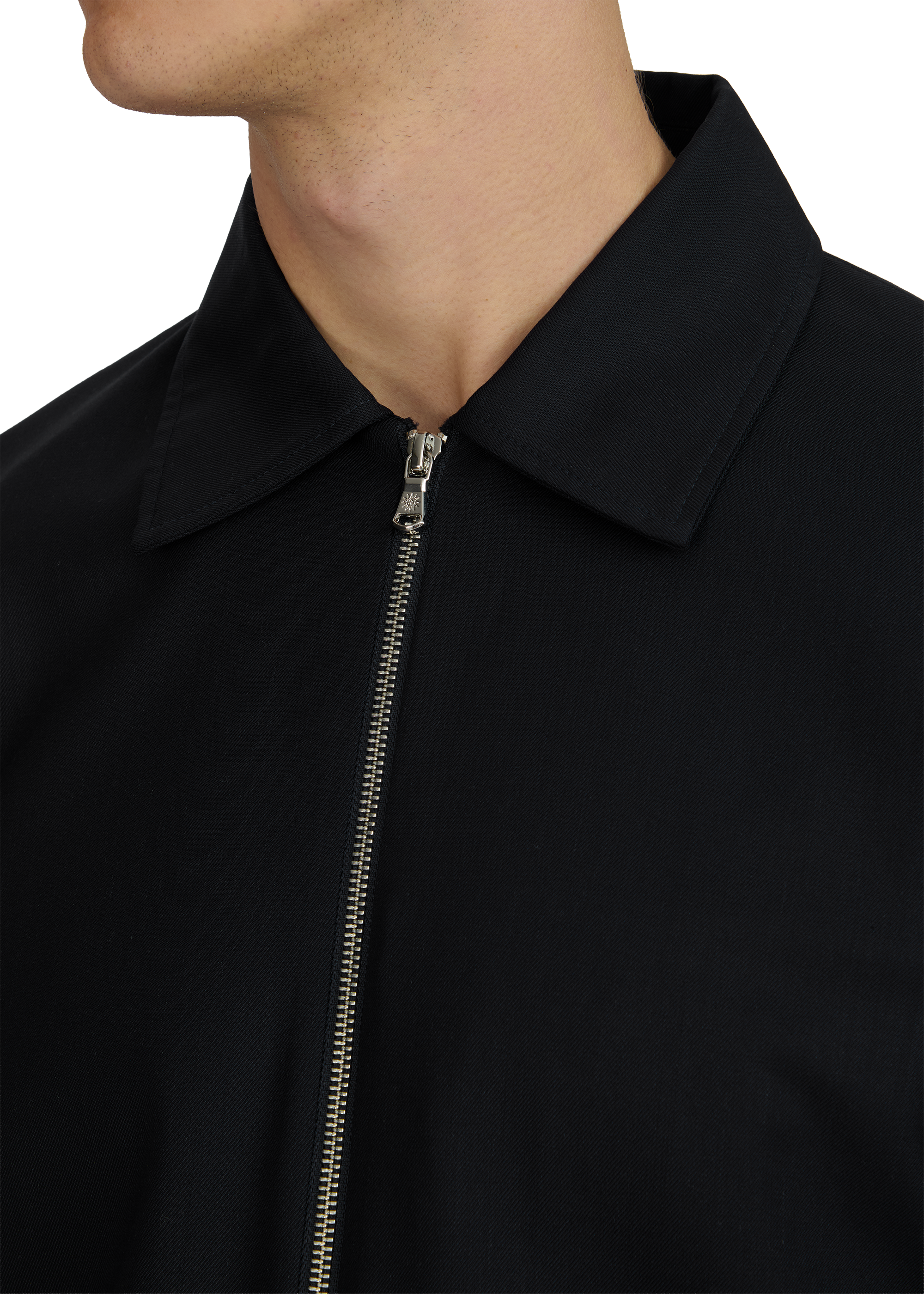 Close-up of a black jacket with a zipper on a white background