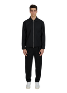 Man wearing a black jacket and pants on a white background