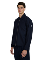 Man wearing a navy blue jacket with a brand logo on a white background