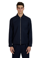 Man wearing a navy blue jacket and pants on a white background