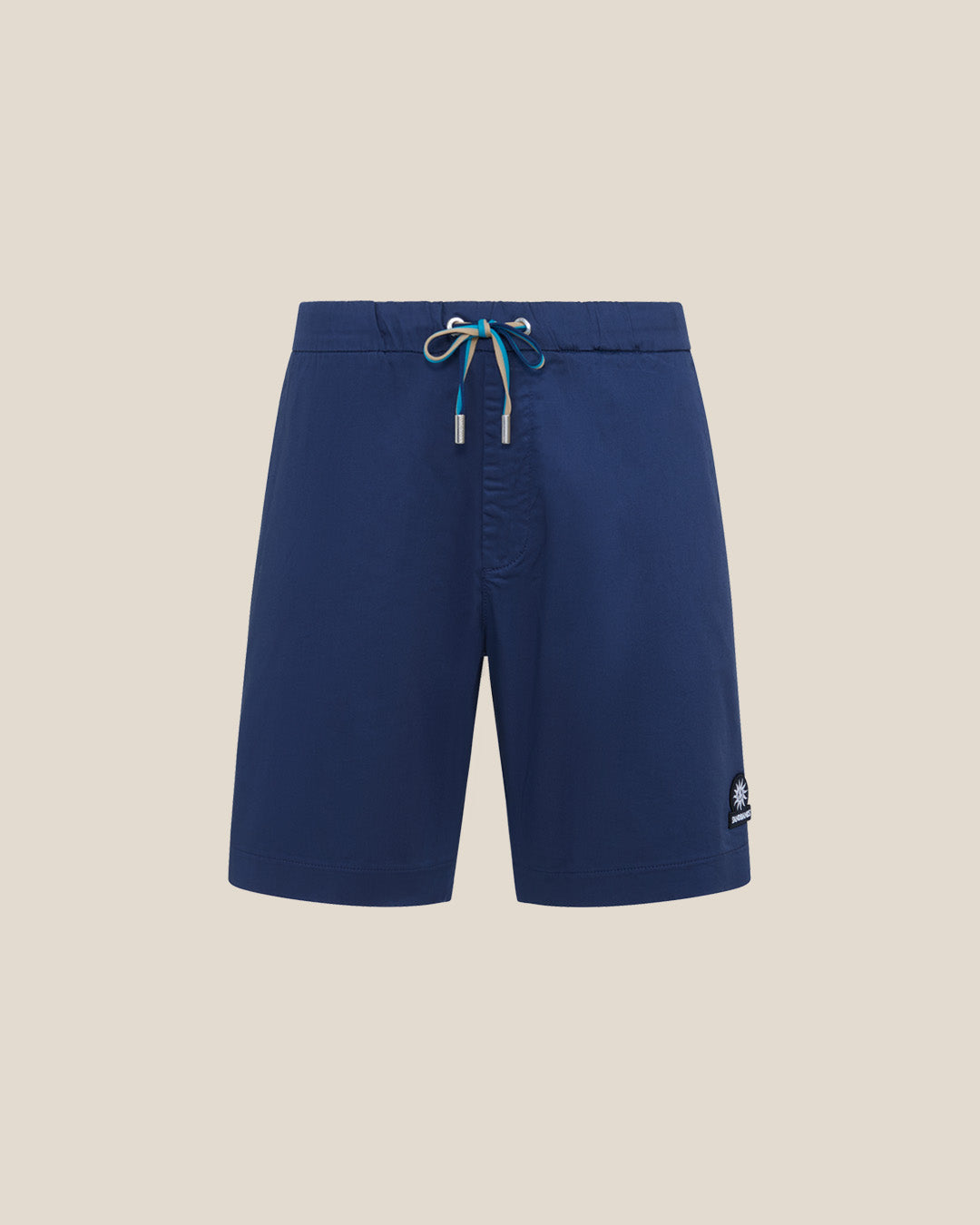 Blue shorts with a logo on a beige background