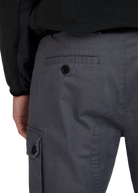 Dark gray cargo pants with a visible button on a white background