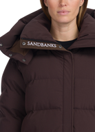 Brown puffer jacket with 'Sandbanks' logo on hood