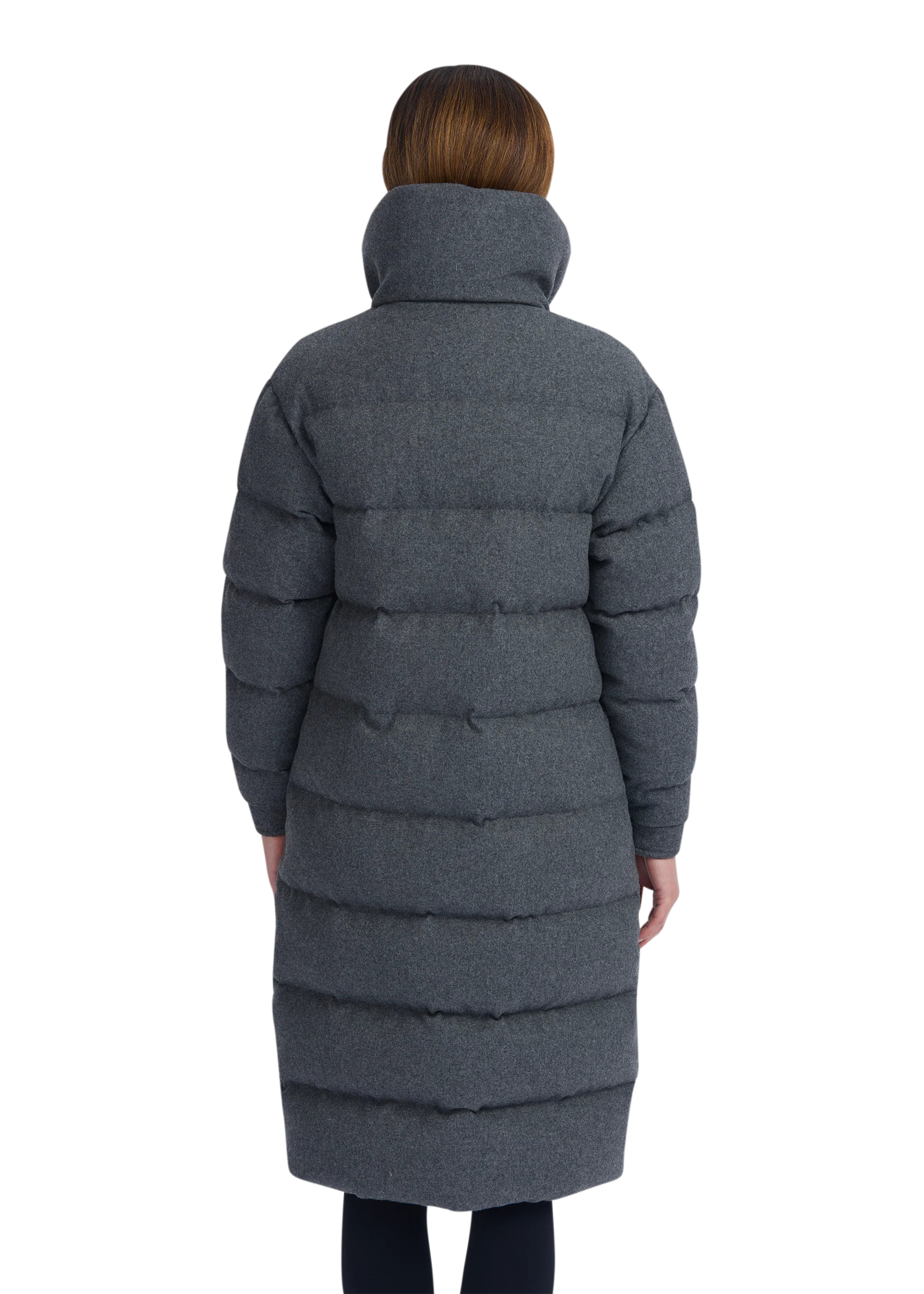 Person wearing a long gray puffer coat on a white background