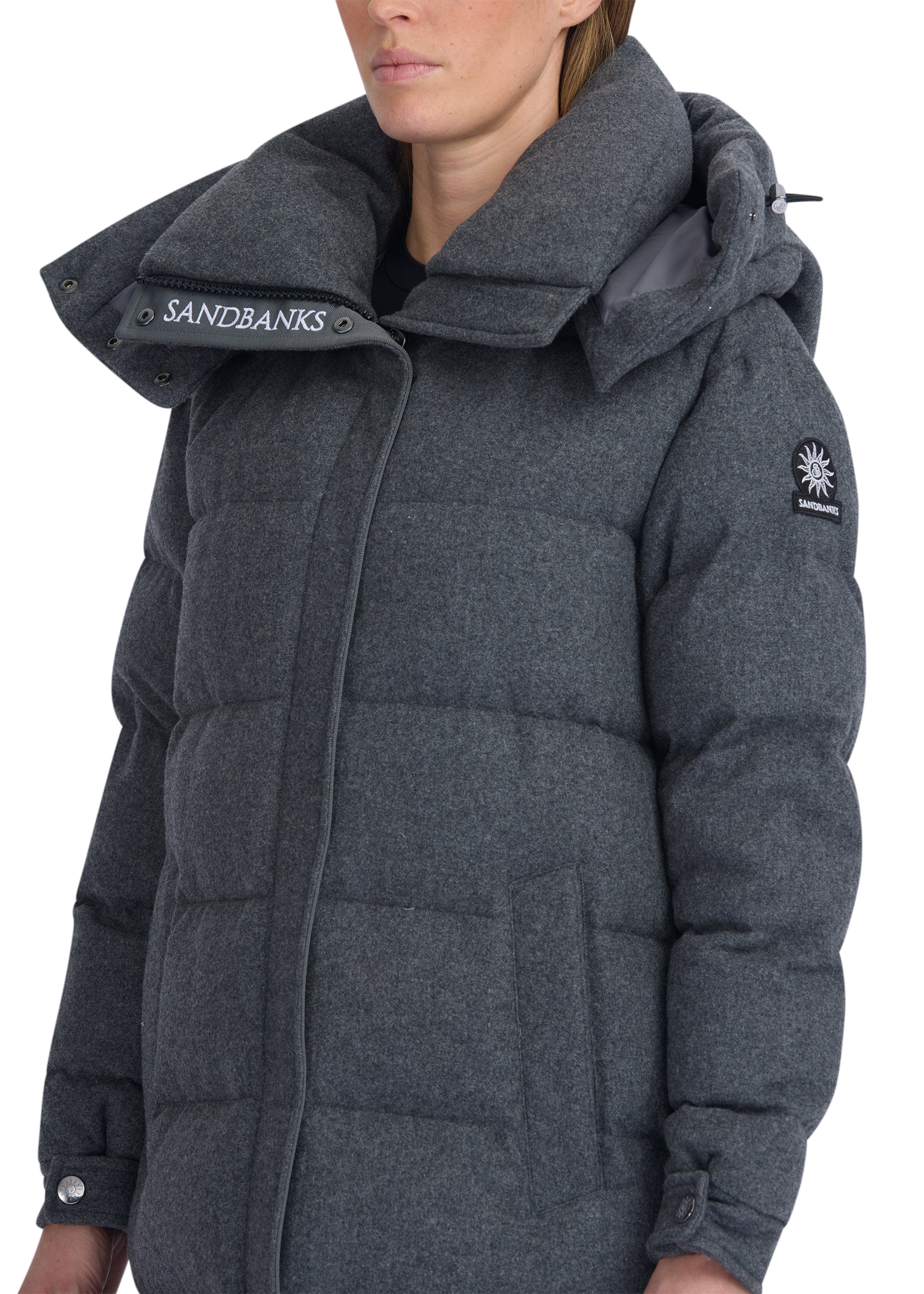 Gray puffer coat with Sandbanks branding on a white background