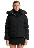 Woman wearing a black puffer jacket with a brand logo on a white background