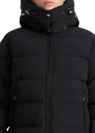 Close-up of a black puffer jacket with a hood on a white background