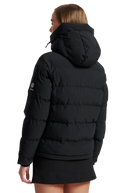 Person wearing a black puffer jacket with a hood on a white background
