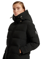 Person wearing a black puffer jacket with a brand logo on a white background