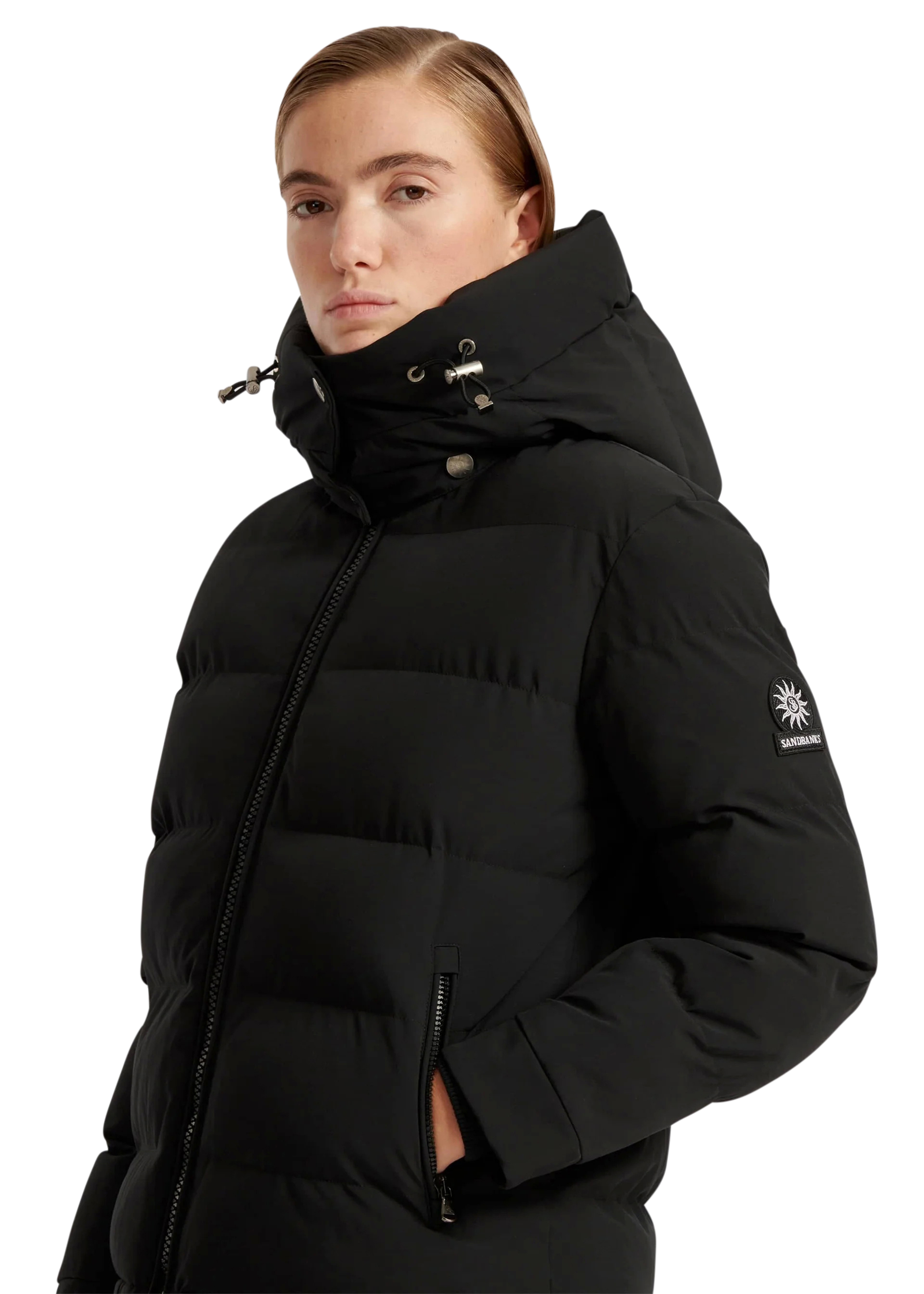 Person wearing a black puffer jacket with a brand logo on a white background