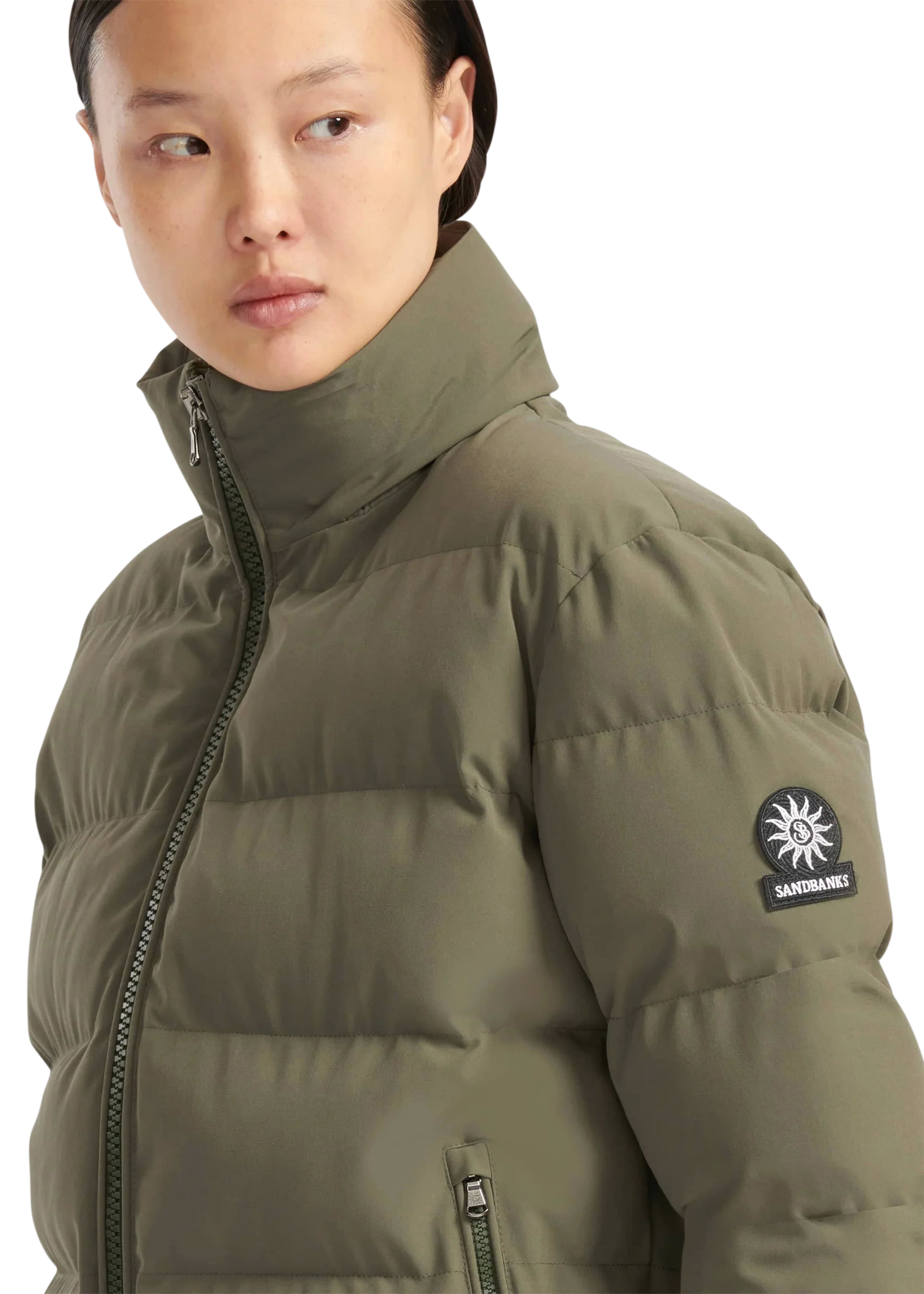 Person wearing a green puffer jacket with a brand logo on a white background