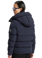 Person wearing a navy blue puffer jacket with a brand logo on a white background