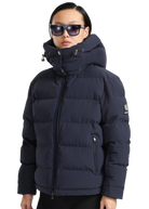 Person wearing a navy blue puffer jacket with a brand logo on a white background