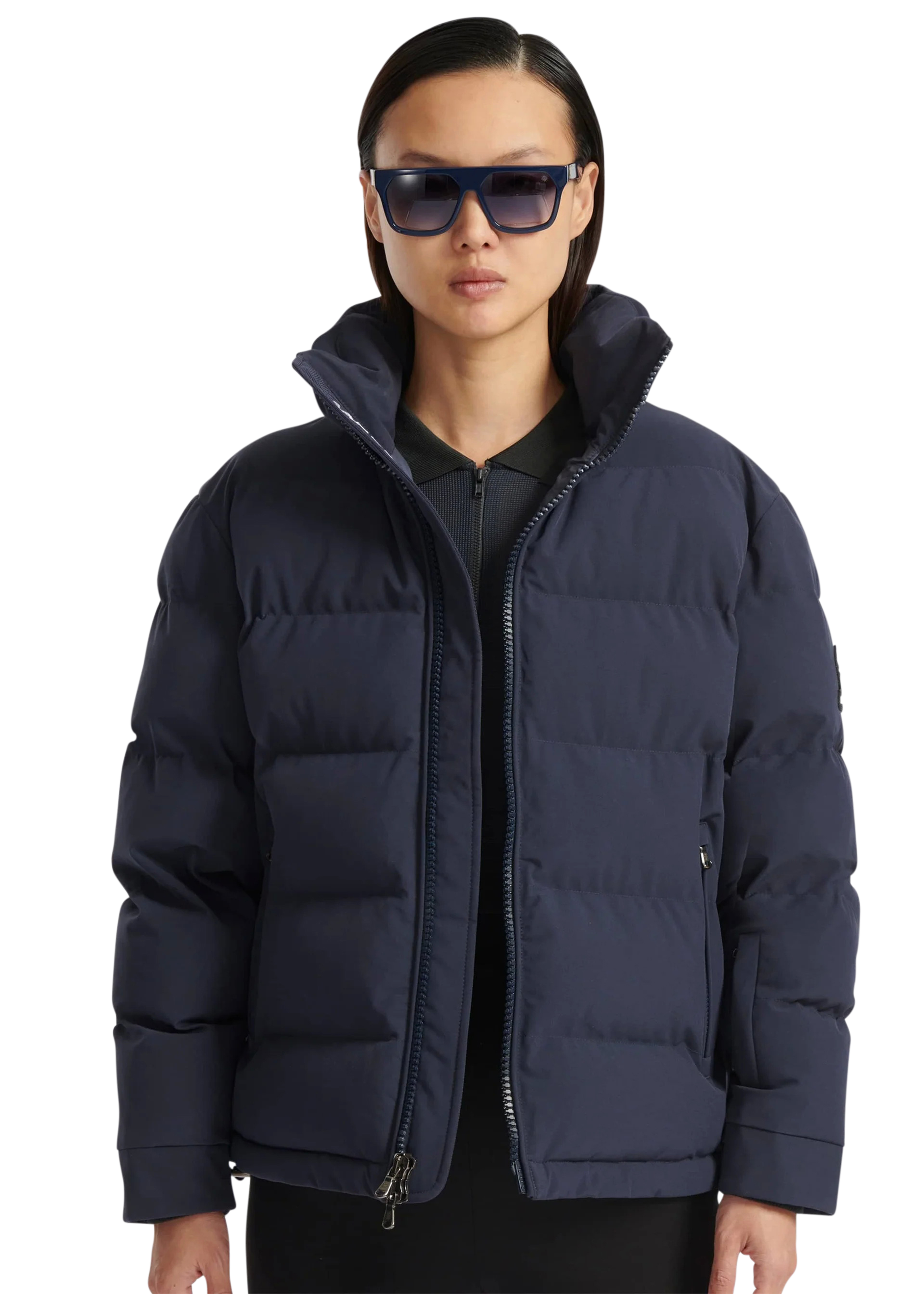 Person wearing a navy blue puffer jacket on a white background