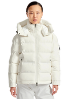 Person wearing a white puffer jacket on a white background