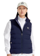 Person wearing a navy puffer vest over a white shirt with a visible brand logo.