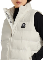 White puffer vest with Sandbanks branding on a white background