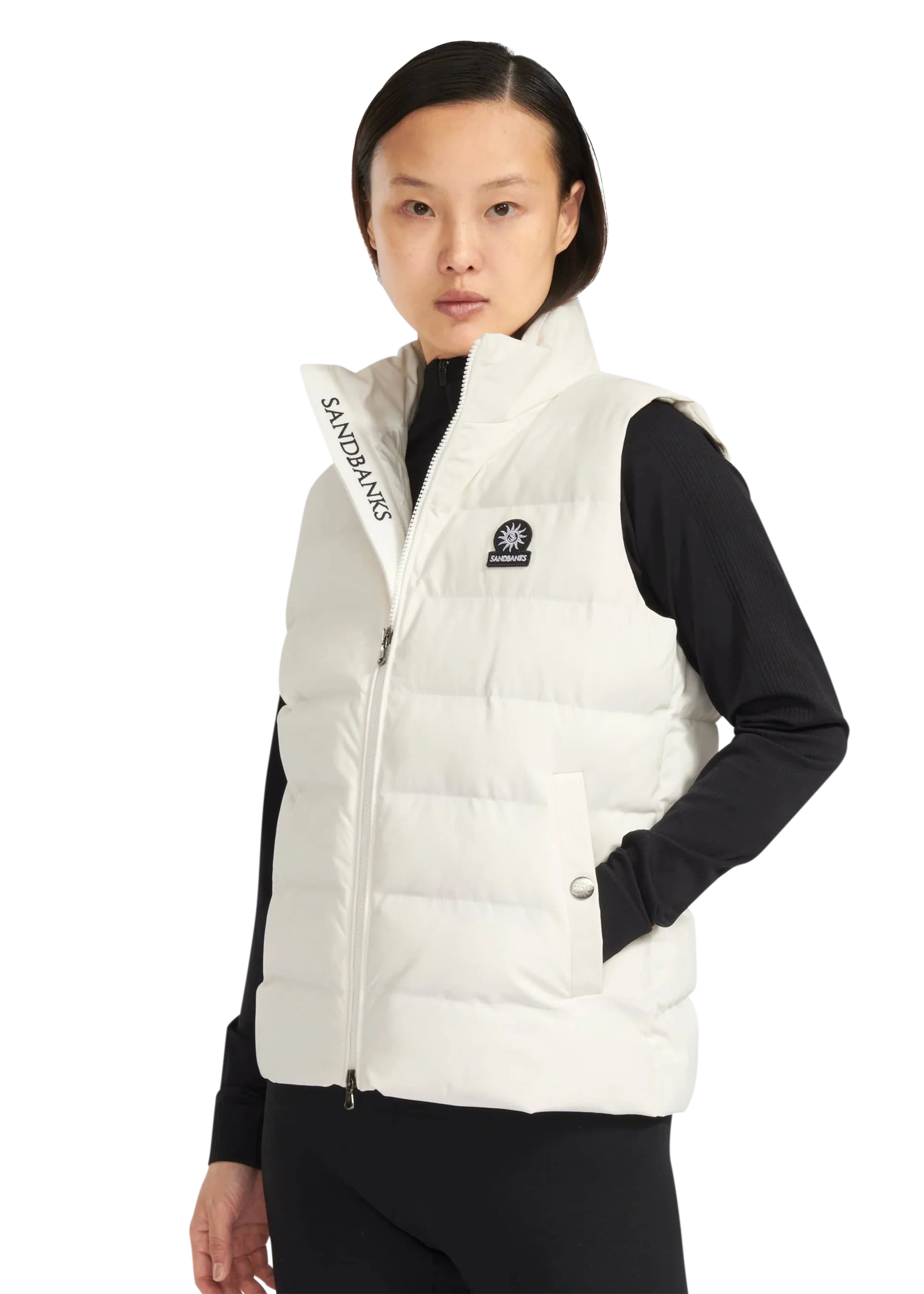 Person wearing a white puffer vest with visible branding on a white background