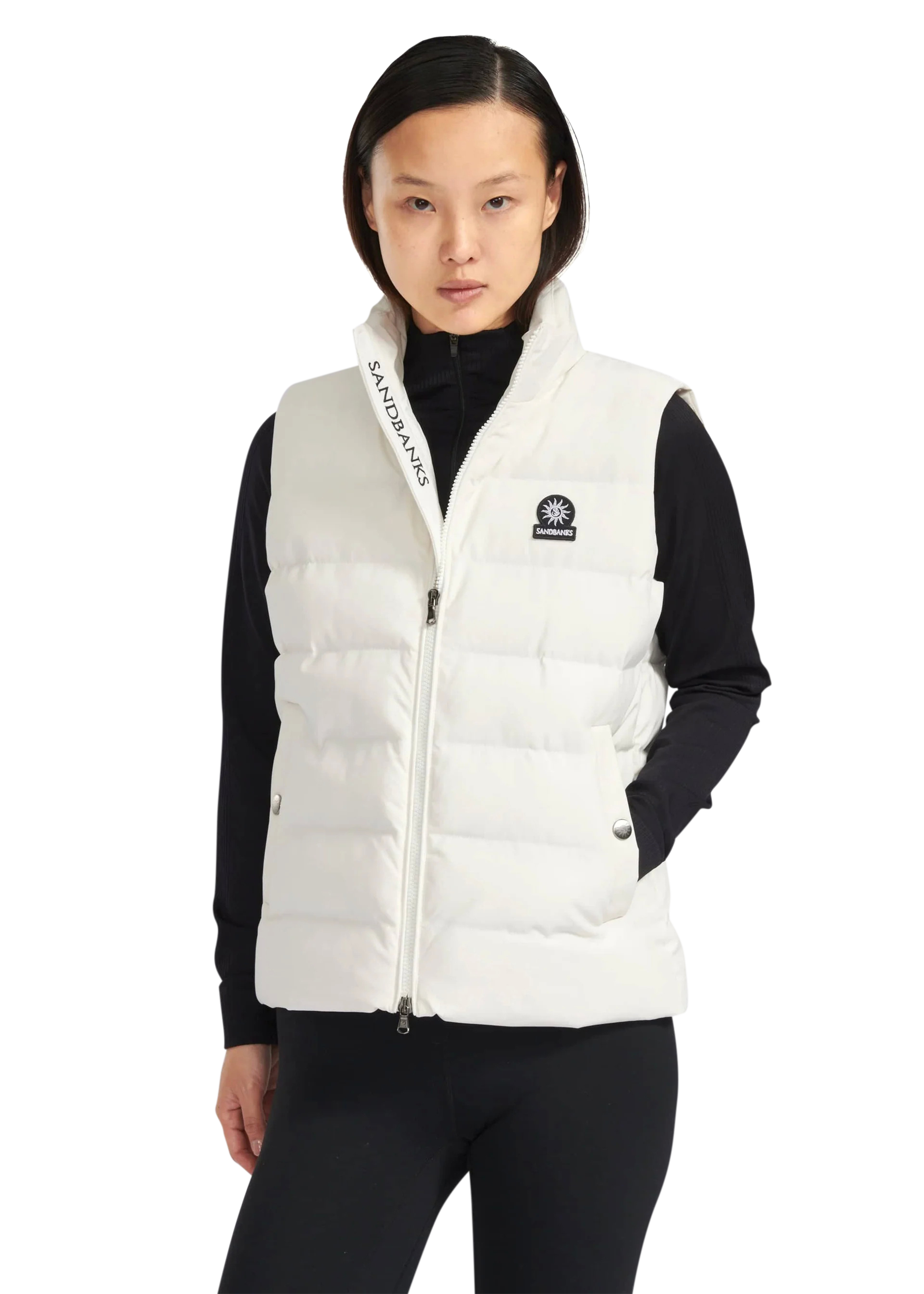 Person wearing a white puffer vest with a brand logo on a white background