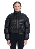 Person wearing a black puffer jacket with 'Sandbanks' branding on a white background