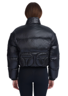 Black puffer jacket worn by a person on a white background
