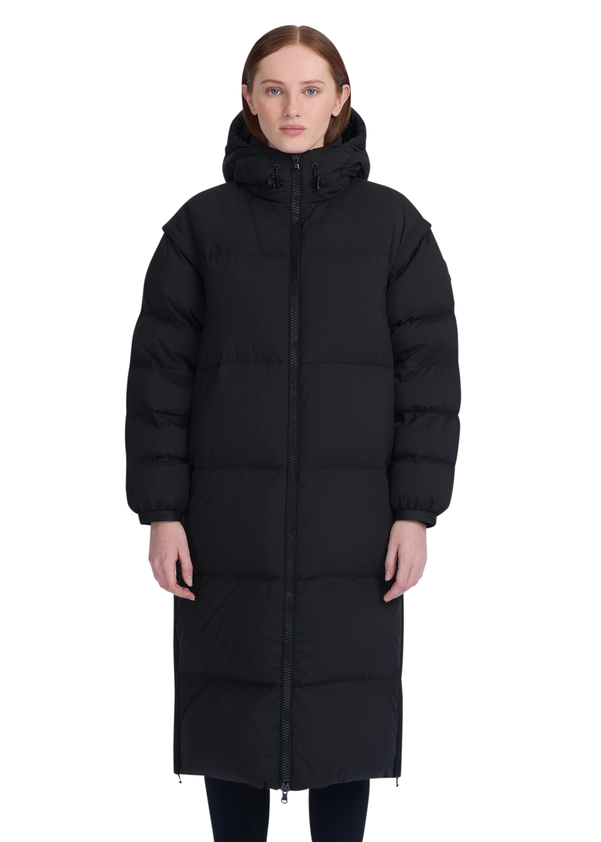 Person wearing a black long puffer coat on a white background