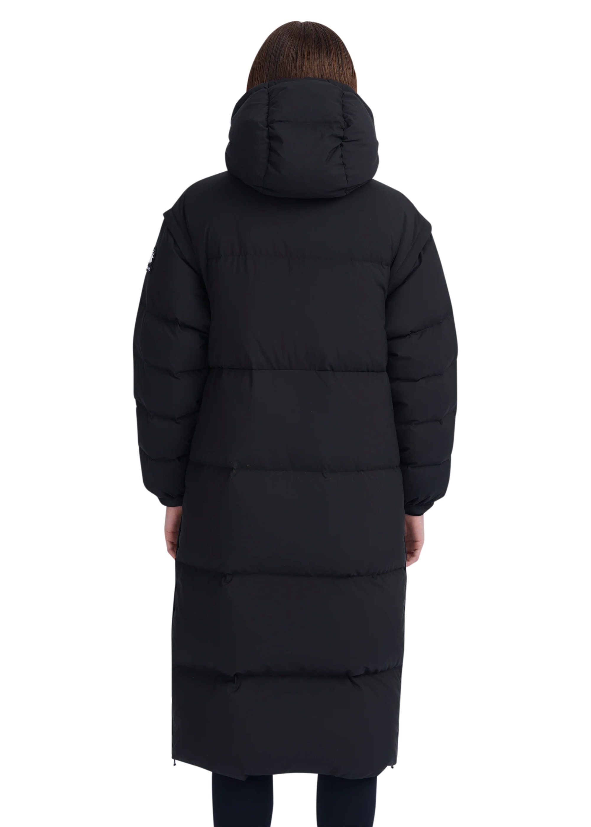 Person wearing a long black puffer coat on a white background