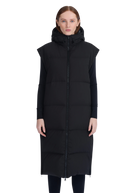 Woman wearing a long black puffer vest on a white background