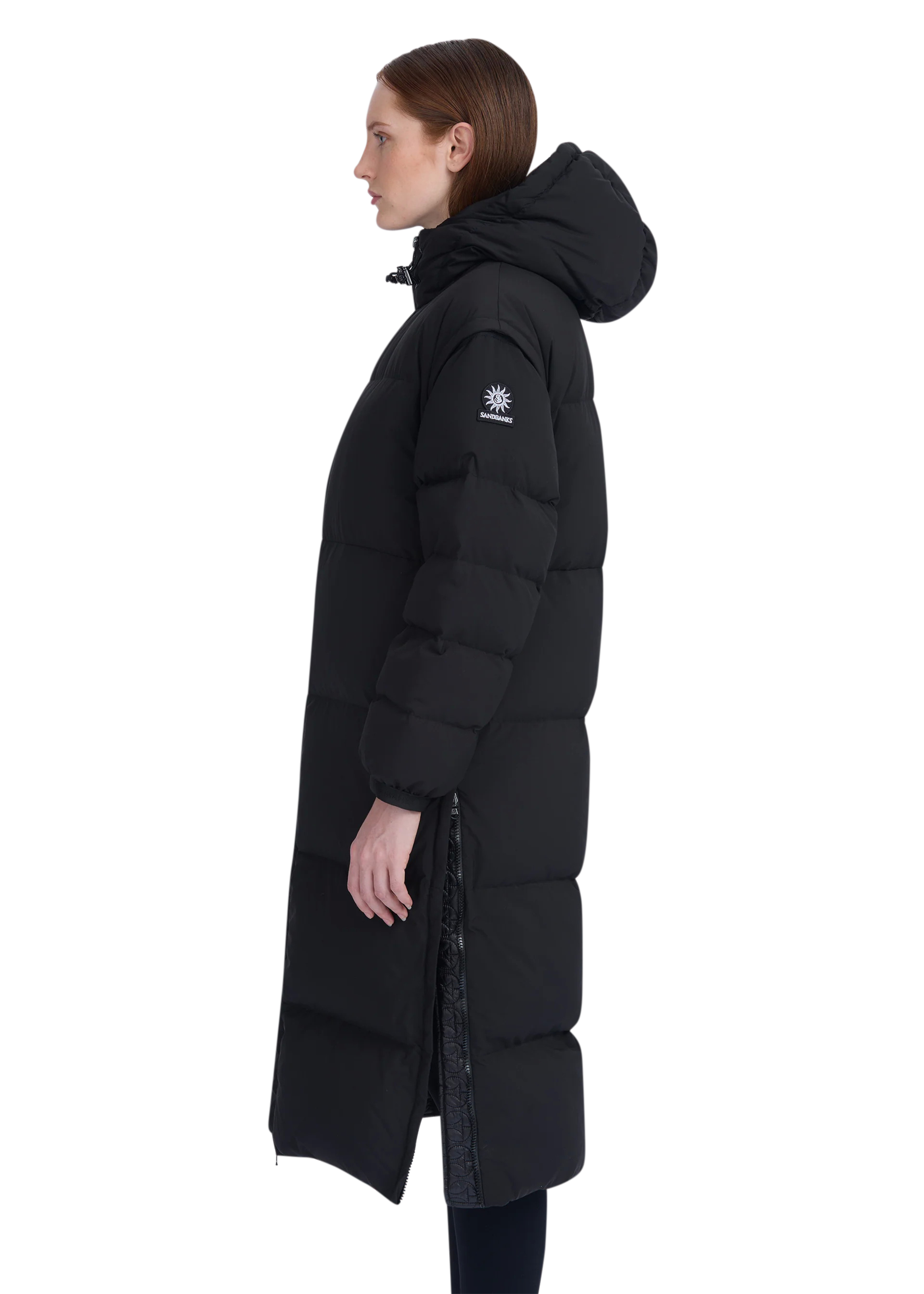 Person wearing a black puffer coat with a brand logo on a white background