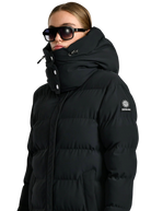 Person wearing a black puffer jacket with a brand logo on a white background