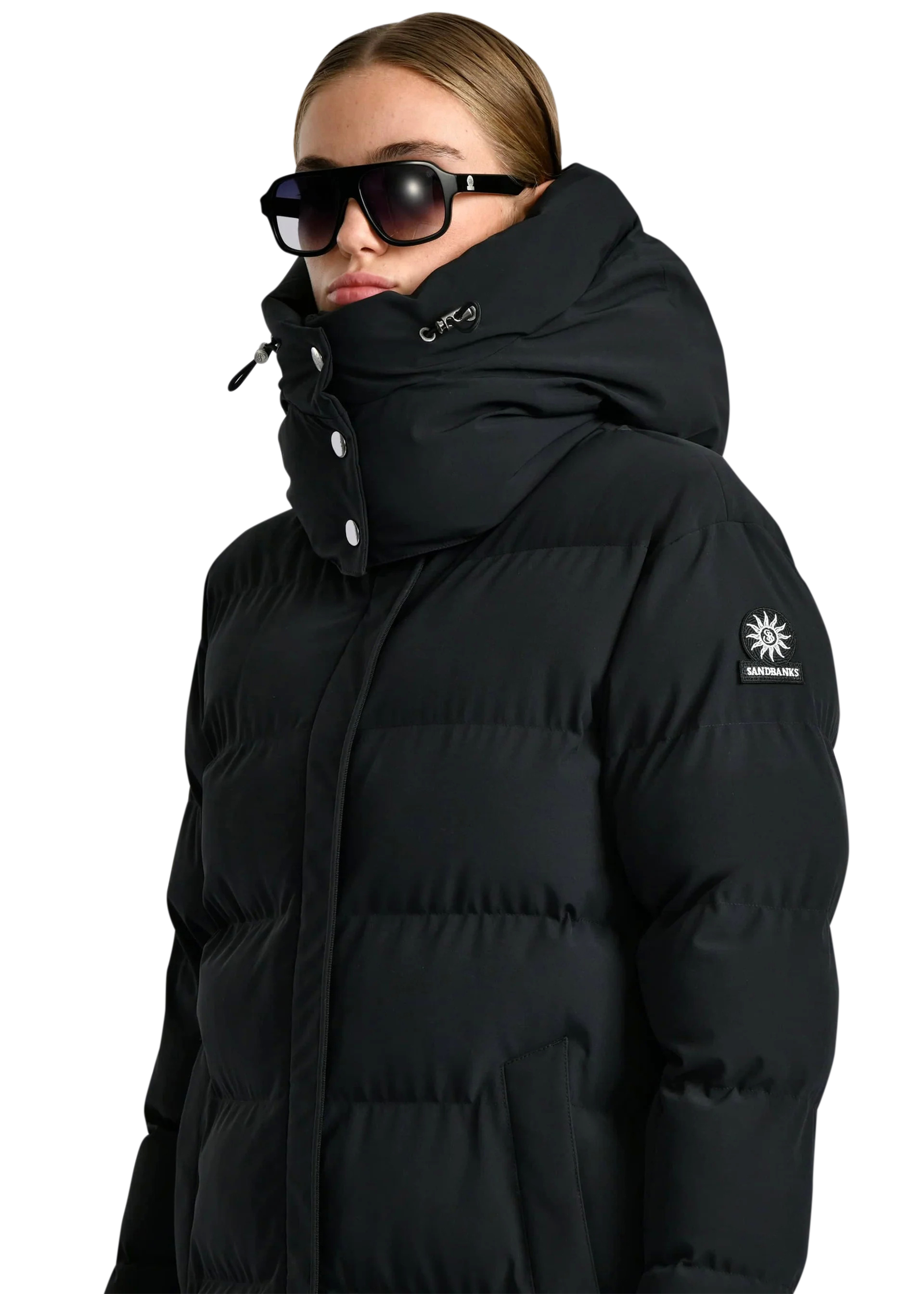 Person wearing a black puffer jacket with a brand logo on a white background