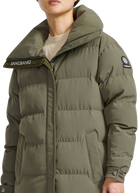Person wearing a green puffer jacket with visible branding on a white background
