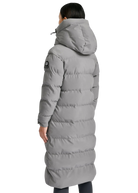 Person wearing a long gray puffer coat on a white background
