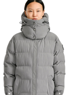 Person wearing a gray puffer jacket on a white background