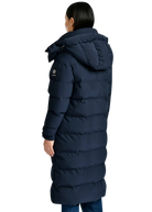 Person wearing a long navy blue puffer coat on a white background
