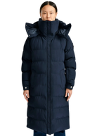 Person wearing a long navy blue puffer coat on a white background